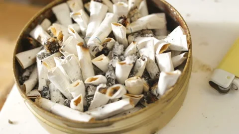 Lots of cigarettes and in a round tin can, close-up. To the right of the ashtray Stock Footage 87738068