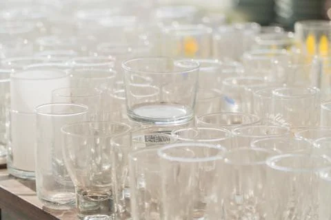 Lots of clean empty glasses of drinks on the bar in a nightclub. Glare and .. Stock Photos