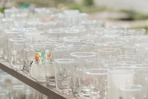 Lots of clean empty glasses of drinks on the bar in a nightclub. Glare and .. Stock Photos