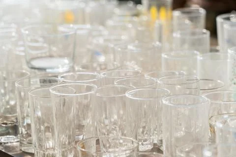 Lots of clean empty glasses of drinks on the bar in a nightclub. Glare and .. Stock Photos