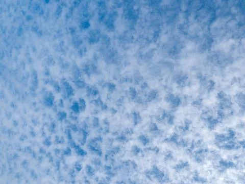 Lots of cloud dots on a partly cloudy blue sky Stock Photos