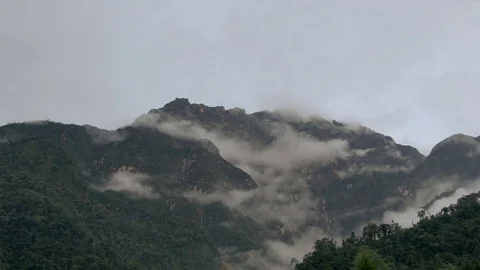 Lots of clouds surounding the mountains Stock Footage 69772843