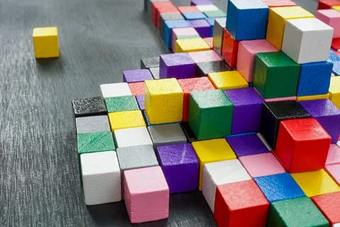 Lots of colorful cubes on the dark surface. Variety abstract concept. Stock Photos