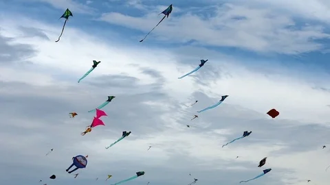 Lots of colourful abstract geometric shaped kites attached to string lines Video stock 106763290