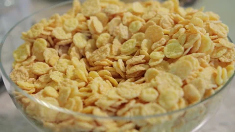 Lots of cornflakes are falling into the plate 스톡 동영상 96311521