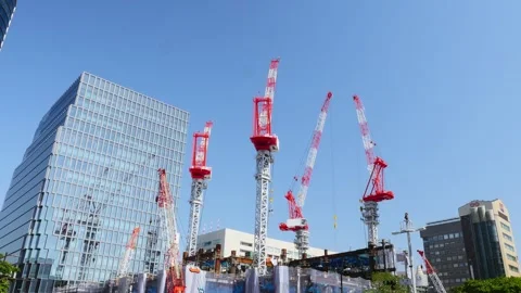 Lots of cranes lifting construction materials in urban area. Construction site o Stock Footage 240854905