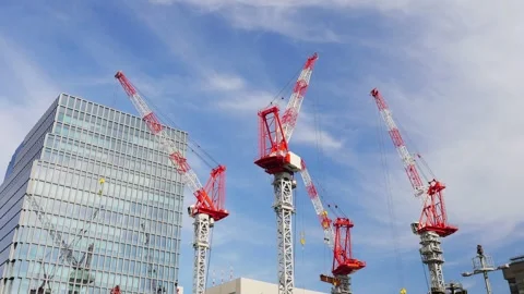 Lots of cranes lifting construction materials in urban area. Construction site o Stock Footage 240857427