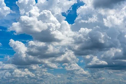 Lots of cumulus clouds far blue daylight sky as natural background Foto stock