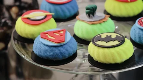 Lots of different decorated cakes for small child who is a fan of comics Stock Footage 204124564