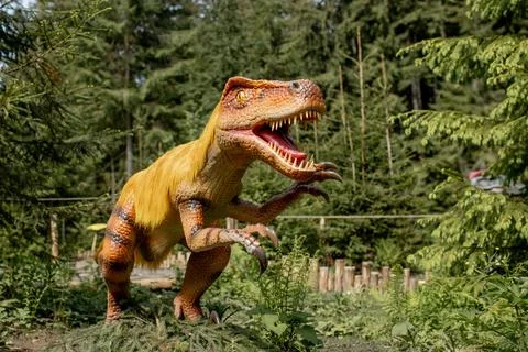 Lots of different dinosaurs in the park Stock Photos