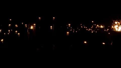 Lots of fire torches lights outside at night Stock Footage 167127503