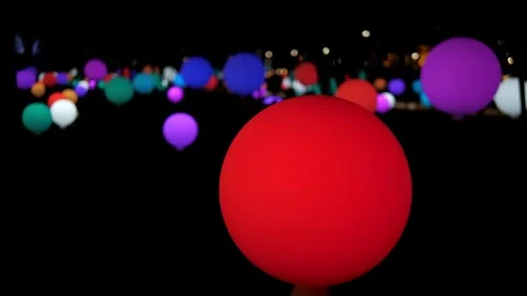 Lots of flashing balls of different colors in the decorated park in the evening. Stock Footage 317931636