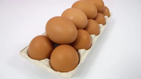 Lots of fresh raw chicken eggs in a cardboard box, curved dolly path shot on  Stock Footage 143376226