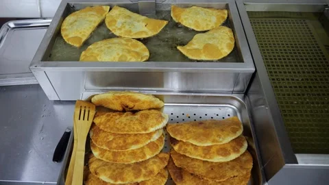 Lots of fried chebureks on the counter in the dining room or on the buffet Stock Footage 341316705
