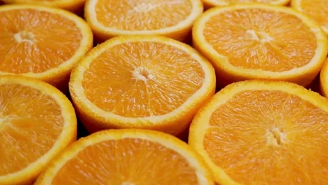 Lots Of Fruit Halves, Oranges, Citrus Fruits, Rotation, Close-up. Abstract Backg Stock Footage 154243400