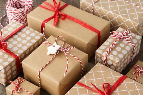 Lots of gift boxes decorated with red ribbon and twine. Stock Photos
