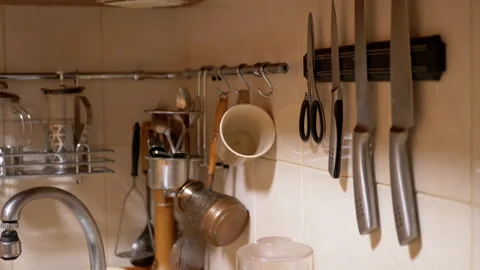 Lots of Glass Spice Jars, Kitchen Utensils, Knives Located in Railing System. 4K Stock Footage 150048432
