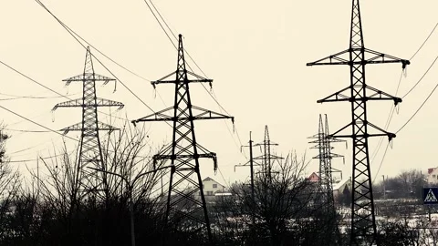 Lots of high-voltage poles with electrical wires. Delivery of electricity to Stock Footage 229596983