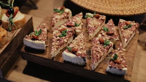 Lots of homemade cheesecakes with mint and walnuts on the table. Sweet desserts Stock Footage 150829243