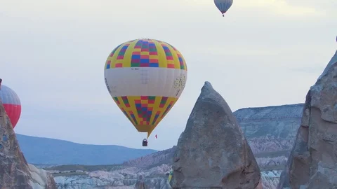 Lots of hot air balloons flying over valleys in Goreme, Cappadocia, Turkey. Stock Footage 100881237