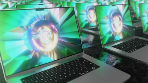 Lots of laptops with a bright colored screen saver moving on a dark background Stock Footage 191960310