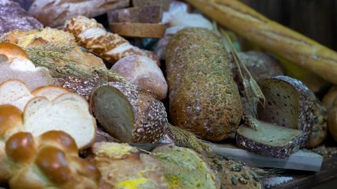 Lots of mixed bread and buns on the table in the bakery. Close-ups  braided brea Stock Footage 109461944