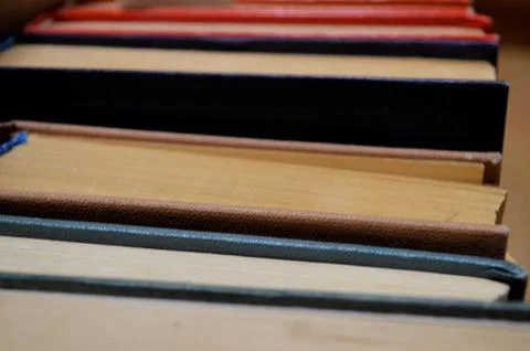 Lots of multi-colored books with multi-colored bookmarks close-up. Stock Photos