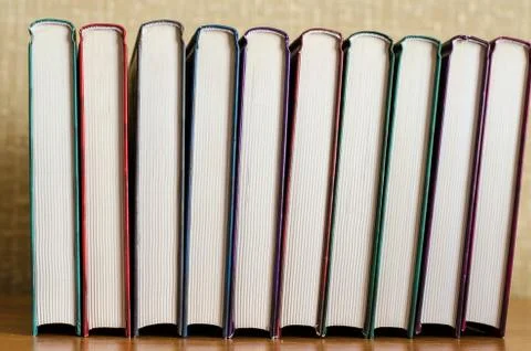 Lots of multi-colored books side view. Home library. Stock Photos