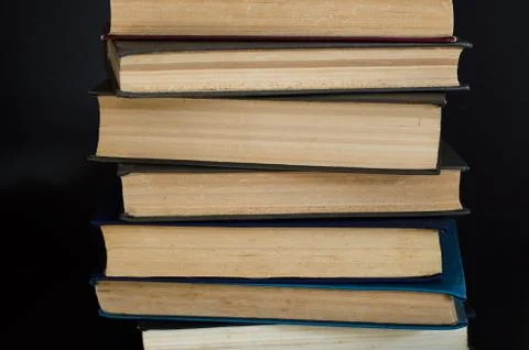 Lots of multi-colored books side view. Home library. Stock Photos