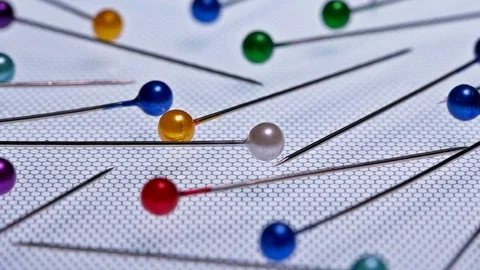 Lots of needles with beads on white background Stock Footage