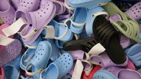 Lots of new multi-colored rubber slippers lying on top of each other. Stock Footage 311475621