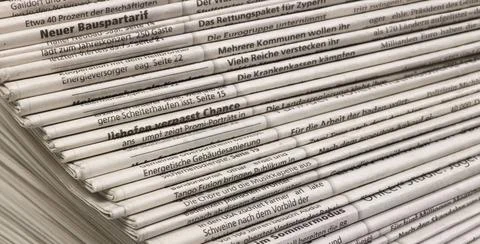 Lots of newspapers full frame background with lots of stacked newspapers C... Stock Photos