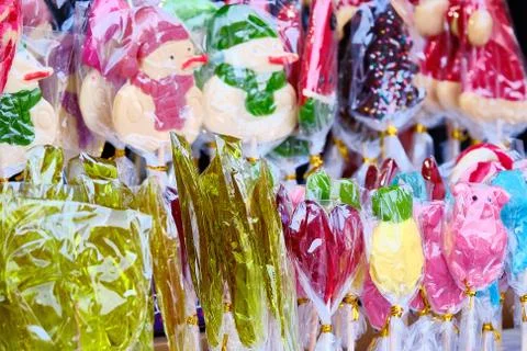 Lots of packaged sweets. Lollipops, candy in different figurines. Stock Photos