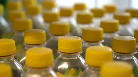 Lots of plastic drinks bottles in the shop by the window. CLOSE-UP. Row of Stock Footage 143972684