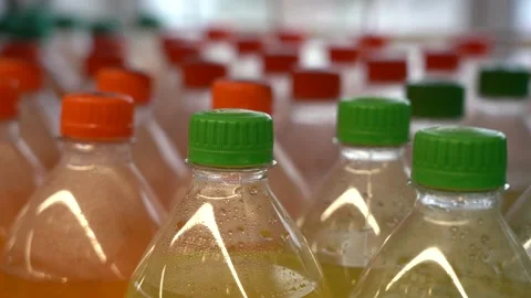Lots of plastic drinks bottles in the shop by the window. CLOSE-UP. Row of Stock Footage 143972844