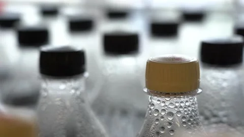 Lots of plastic drinks bottles in the shop by the window. CLOSE-UP. Row of Stock Footage 146736532