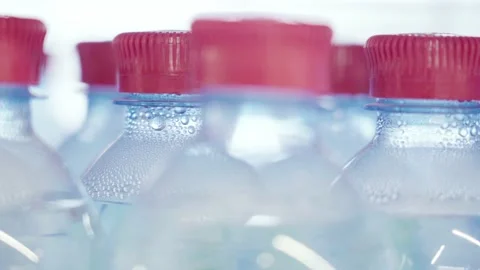 Lots of plastic drinks bottles in the shop by the window. CLOSE-UP. Row of Stock Footage 152144649