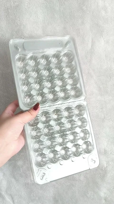 Lots of plastic trays for quail eggs in your hands Stock-Footage 332409824