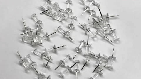 Lots of pushpins on a white background. Spinning objects. Rotating objects. Stock Footage 151150568