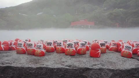 Lots of red Daruma dolls on stone platform at Katsuoji Temple in Osaka Stock Footage 345186868