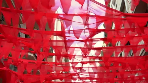 Lots of red flags over a pedestrian street. canopy for shade on a hot day 스톡 동영상 114511789