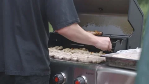 Lots of sausages being cooked on a bbq at party Stock Footage 247331268