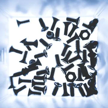 Lots of small bolts for attaching computer parts. Macro photography Stock Photos