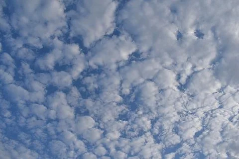 Lots of small clouds on a blue sky. Stock Photos