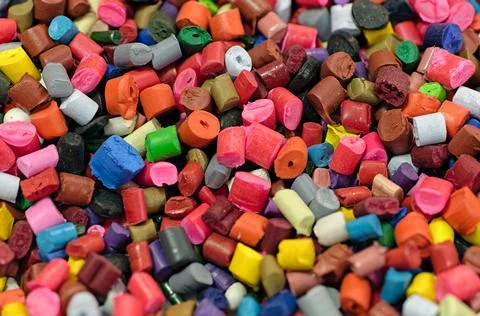 Lots of small pieces of multi-colored plastic, line for the production of p.. Stock Photos
