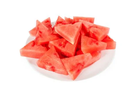 Lots of small triangular slices of ripe red watermelon on a plate. Isolated o Stock Photos
