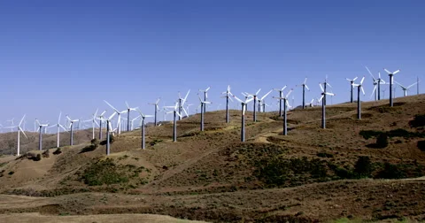 Lots of smaller wind turbines on a hillside in the Tehachapi Mountains 4K Stock Footage 64283580