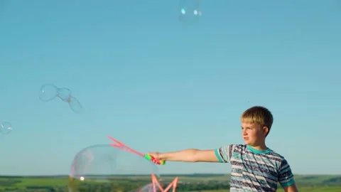 Lots of soap bubbles, child experiences emotions of happiness. Holiday concept Stock Footage 175517178