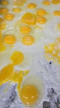 Lots of Sunny Side Up Fried Eggs Cooking at the grill Together For Breakfas.. Stock Photos