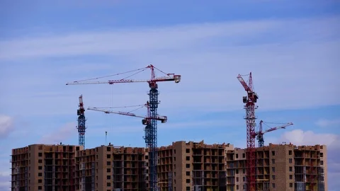 Lots of tall construction cranes. Sky and clouds in the background.  Video stock 108648215